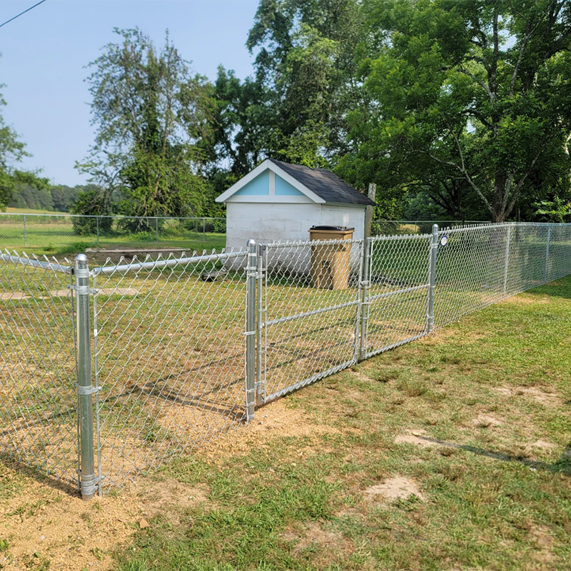 silver chain link fence surrounding storage shed